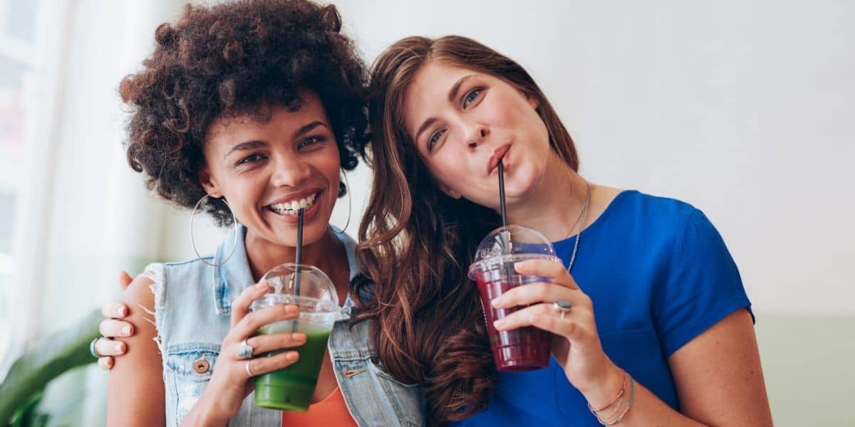 Two ladies drinking juice